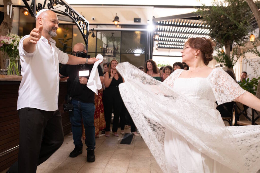 החתן והכלה רוקדים יחד בחתונה קטנה