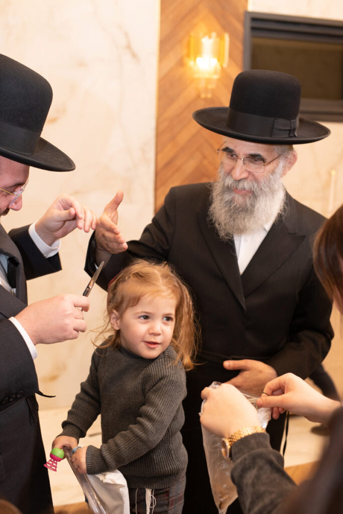 צלם חלאקה בבני ברק מתעד שמחת חלאקה בהשתתפות רבנים.