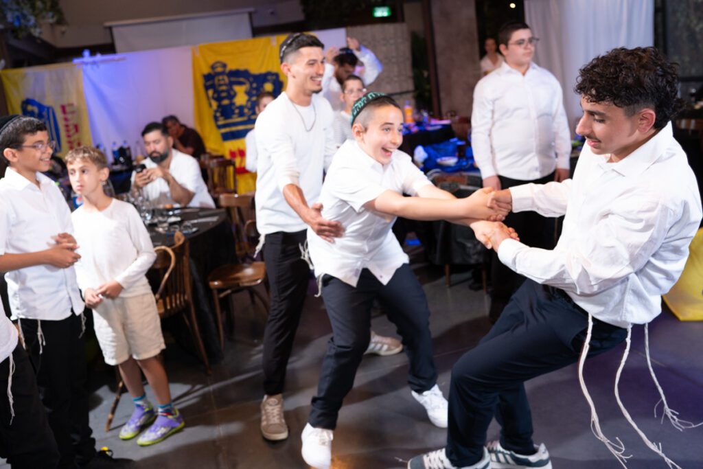 ריקודים סוערים ותנופת ידיים בשמחת בר מצווה חבדית באולם, צילום אירועים לציבור החרדי.