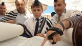 חתן הבר מצווה בעליה לתורה בכותל המערבי בירושלים